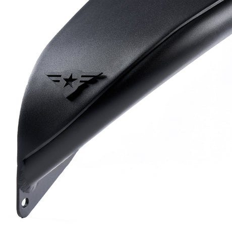 Close-up view of the edge of a front black aluminum fender flare for a Jeep Wrangler. The fender features a textured powder-coated finish and includes a removable and paintable Combat Off Road logo near the edge. Designed for durability and off-road performance, the fender flare also has pre-drilled holes for easy installation.