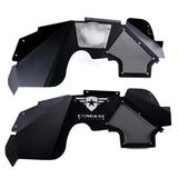 A set of black front inner fender liners for Jeep Wranglers, featuring a durable powder-coated finish and precision-cut mesh panels for ventilation. Both liners include the Combat Off Road logo with removable, paintable backing plates for customization. The top liner is displayed with the backing plate from the rear view, highlighting the design's versatility. These liners provide enhanced protection and airflow for off-road performance and style.