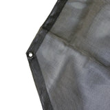 Close up of the edge of a black mesh Jeep sunshade showing the reinforced edge and metal mounting grommet