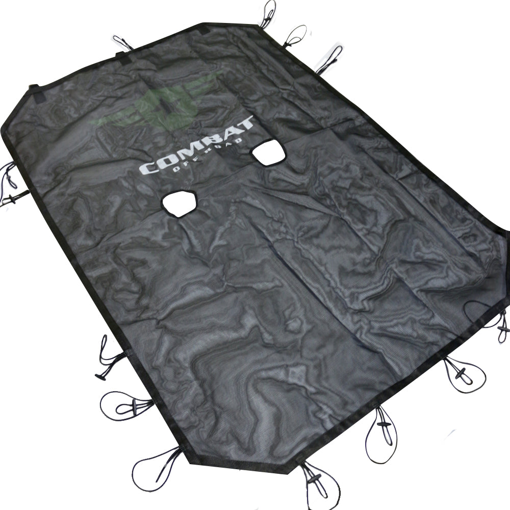 Black mesh sunshade for a 4-door Jeep JK, designed to reduce sunlight exposure while maintaining airflow. Features the Combat Off Road logo prominently displayed in white with a subtle green backing at the center. The sunshade has two cutouts for the front seat area and is equipped with durable bungee cords along the edges for secure attachment to the Jeep's roll bars. The shade's material is lightweight and sturdy, suitable for off-road adventures.